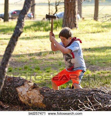 Caucasian boy chopping log with axe View Large Photo Image Stock Image - Caucasian boy chopping log with axe. Fotosearch
