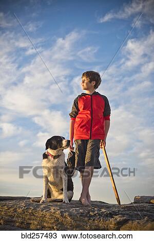 Caucasian boy hiking with dog View Large Photo Image Stock Image - Caucasian boy hiking with dog. Fotosearch
