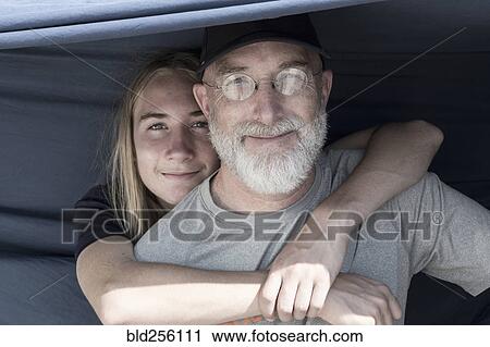Stock Image - Caucasian boy hugging father. Fotosearch