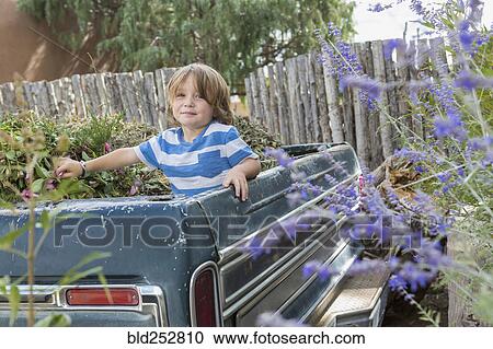 Caucasian boy playing in the truck bed View Large Photo Image Stock Image - Caucasian boy playing in the truck bed. Fotosearch