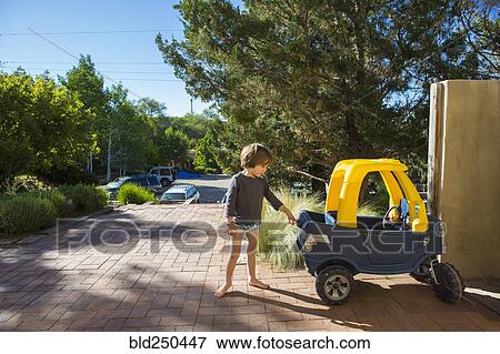 Caucasian boy playing with toy car View Large Photo Image Stock Photo - Caucasian boy playing with toy car. Fotosearch