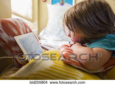 Picture - Caucasian boy watching digital tablet. Fotosearch