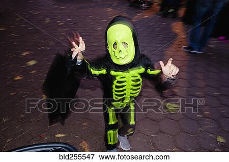 Stock Photo - Caucasian boy wearing skeleton Halloween costume. Fotosearch