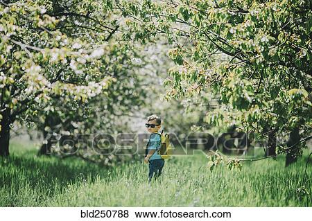 Caucasian boy wearing sunglasses and backpack in grass View Large Photo Image Stock Photo - Caucasian boy wearing sunglasses and backpack in grass. Fotosearch