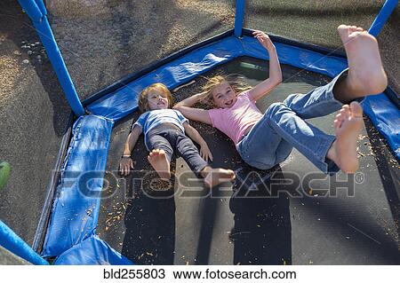 Caucasian brother and sister bouncing on trampoline View Large Photo Image Stock Image - Caucasian brother and sister bouncing on trampoline. Fotosearch