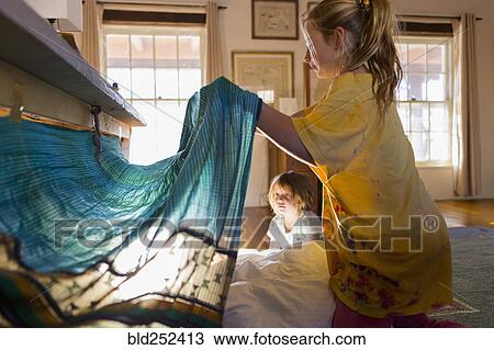 Caucasian brother and sister playing with fort under table View Large Photo Image Stock Image - Caucasian brother and sister playing with fort under table. Fotosearch