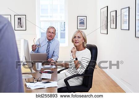 Caucasian business people talking at table View Large Photo Image Stock Image - Caucasian business people talking at table. Fotosearch