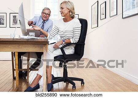 Caucasian businessman and businesswoman using computer View Large Photo Image Stock Image - Caucasian businessman and businesswoman using computer. Fotosearch