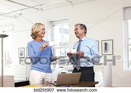 Caucasian businessman and businesswoman drinking coffee View Large Photo Image Stock Photo - Caucasian businessman and businesswoman drinking coffee. Fotosearch