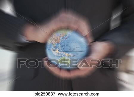 Caucasian businessman holding defocused globe in hands View Large Photo Image Stock Photo - Caucasian businessman holding defocused globe in hands. Fotosearch
