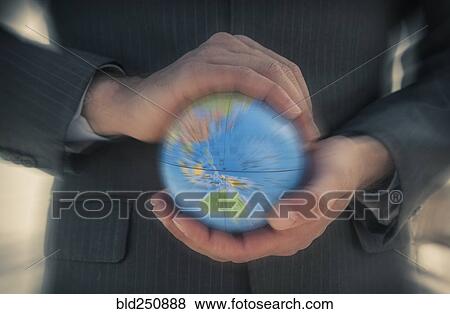 Caucasian businessman holding defocused globe in hands View Large Photo Image Stock Photo - Caucasian businessman holding defocused globe in hands. Fotosearch