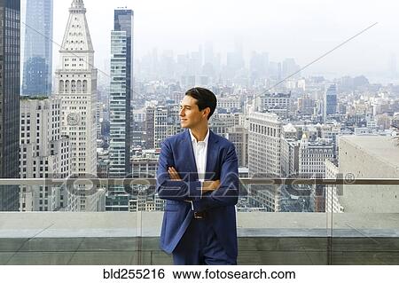 Caucasian businessman leaning on urban rooftop View Large Photo Image Stock Photograph - Caucasian businessman leaning on urban rooftop. Fotosearch