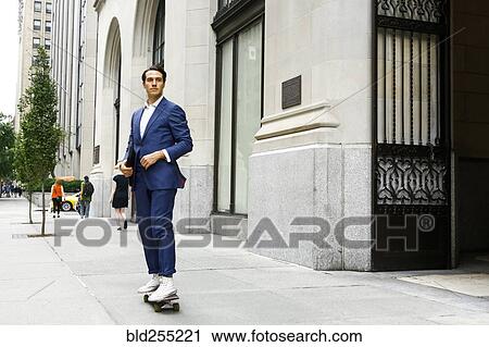 Caucasian businessman skateboarding on urban sidewalk View Large Photo Image Stock Image - Caucasian businessman skateboarding on urban sidewalk. Fotosearch