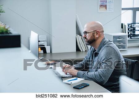 Stock Image - Caucasian businessman using computer. Fotosearch