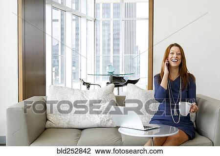 Caucasian businesswoman talking on cell phone and laughing View Large Photo Image Stock Image - Caucasian businesswoman talking on cell phone and laughing. Fotosearch