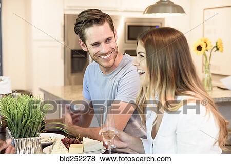 Caucasian couple drinking champagne and laughing View Large Photo Image Stock Photo - Caucasian couple drinking champagne and laughing. Fotosearch