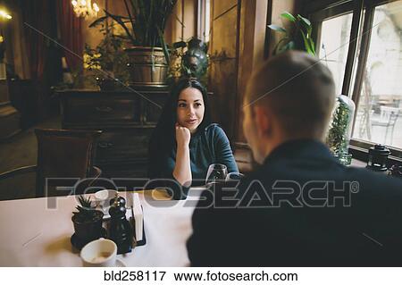 Stock Photo - Caucasian couple drinking wine in restaurant. Fotosearch