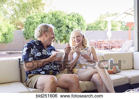 Caucasian couple eating bowls of fruit View Large Photo Image Stock Photograph - Caucasian couple eating bowls of fruit. Fotosearch