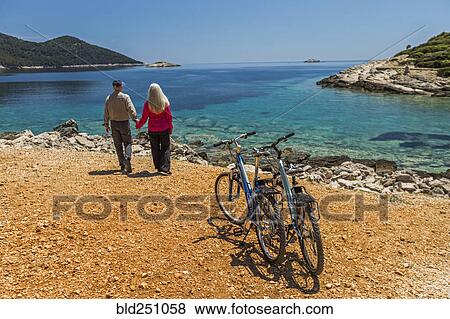 Caucasian couple holding hands near lake View Large Photo Image Stock Photo - Caucasian couple holding hands near lake. Fotosearch