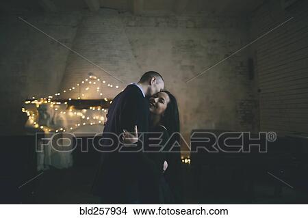 Caucasian couple hugging near fireplace View Large Photo Image Picture - Caucasian couple hugging near fireplace. Fotosearch