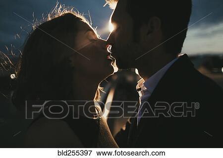 Caucasian couple kissing at night View Large Photo Image Stock Photo - Caucasian couple kissing at night. Fotosearch
