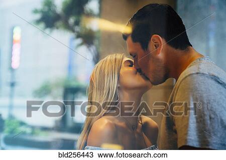 Caucasian couple kissing behind window View Large Photo Image Stock Image - Caucasian couple kissing behind window. Fotosearch