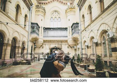 Caucasian couple kissing in courtyard View Large Photo Image Stock Image - Caucasian couple kissing in courtyard. Fotosearch