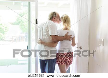 Caucasian couple kissing in patio doorway View Large Photo Image Stock Image - Caucasian couple kissing in patio doorway. Fotosearch