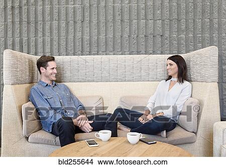 Picture - Caucasian couple relaxing on sofa. Fotosearch