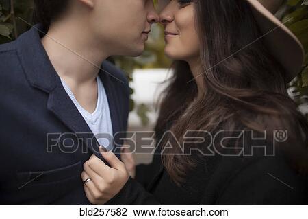 Stock Image - Caucasian couple rubbing noses. Fotosearch