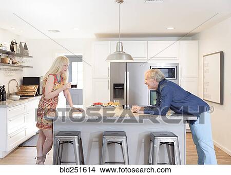 Caucasian couple talking in the kitchen View Large Photo Image Picture - Caucasian couple talking in the kitchen. Fotosearch
