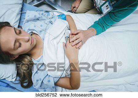 Caucasian doctor comforting patient in hospital bed View Large Photo Image Stock Image - Caucasian doctor comforting patient in hospital bed. Fotosearch