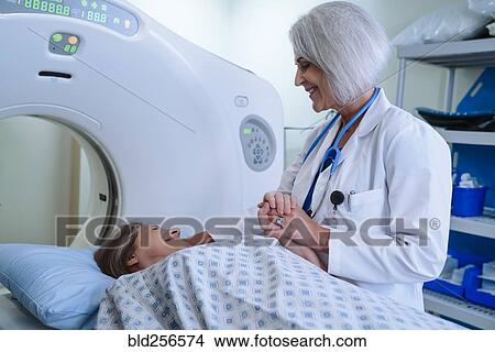 Caucasian doctor comforting patient near scanner View Large Photo Image Picture - Caucasian doctor comforting patient near scanner. Fotosearch