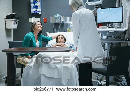 Caucasian doctor talking to mother and daughter in hospital View Large Photo Image Stock Image - Caucasian doctor talking to mother and daughter in hospital. Fotosearch