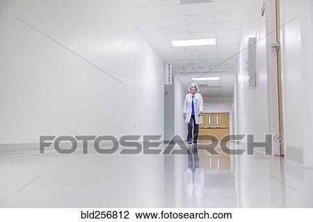 Caucasian doctor walking in hospital View Large Photo Image Stock Image - Caucasian doctor walking in hospital. Fotosearch