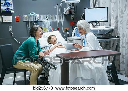 Caucasian doctor with digital tablet talking to mother and daughter in hospital View Large Photo Image Stock Image - Caucasian doctor with digital tablet talking to mother and daughter in hospital. Fotosearch