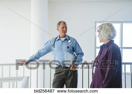 Stock Photo - Caucasian doctors talking. Fotosearch