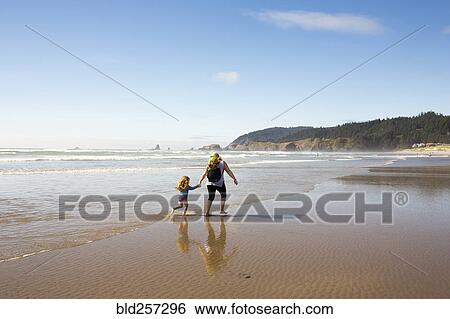 Caucasian family holding hands and running on beach View Large Photo Image Stock Photograph - Caucasian family holding hands and running on beach. Fotosearch