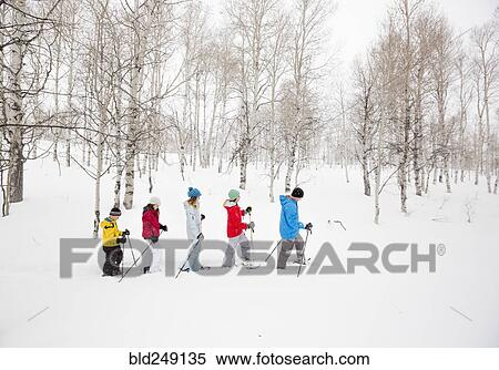 Stock Photography - Caucasian family snowshoeing. Fotosearch