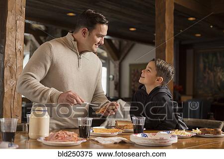Caucasian father making sandwich for son at table View Large Photo Image Stock Photography - Caucasian father making sandwich for son at table. Fotosearch