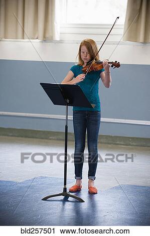 Stock Image - Caucasian girl 1acticing violin. Fotosearch