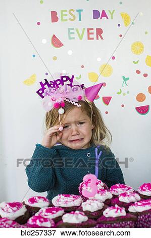 Caucasian girl crying over tray of cupcakes for birthday View Large Photo Image Stock Photo - Caucasian girl crying over tray of cupcakes for birthday. Fotosearch