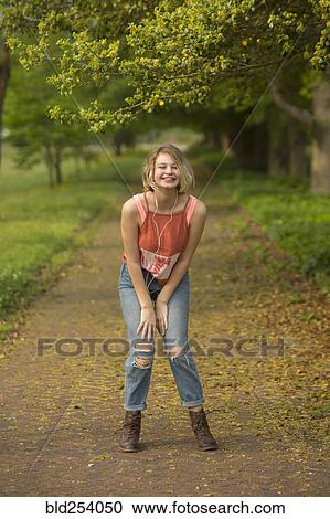 Caucasian girl dancing in park listening to earbuds View Large Photo Image Stock Image - Caucasian girl dancing in park listening to earbuds. Fotosearch
