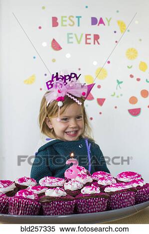 Caucasian girl holding tray of cupcakes for birthday View Large Photo Image Stock Photography - Caucasian girl holding tray of cupcakes for birthday. Fotosearch