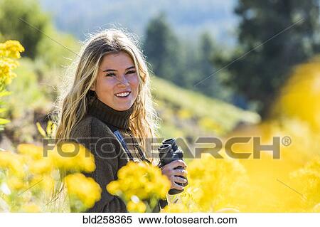 Caucasian girl in field holding binoculars View Large Photo Image Stock Photography - Caucasian girl in field holding binoculars. Fotosearch