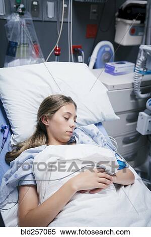 Stock Photography - Caucasian girl laying in hospital bed. Fotosearch