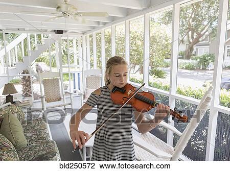 Caucasian girl playing violin on patio View Large Photo Image Stock Image - Caucasian girl playing violin on patio. Fotosearch