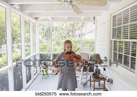 Caucasian girl playing violin on patio View Large Photo Image Stock Photography - Caucasian girl playing violin on patio. Fotosearch