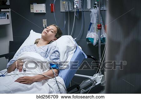 Stock Photo - Caucasian girl sleeping in hospital bed. Fotosearch