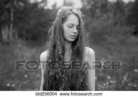 Caucasian girl standing in field with fuzz in hair View Large Photo Image Picture - Caucasian girl standing in field with fuzz in hair. Fotosearch
